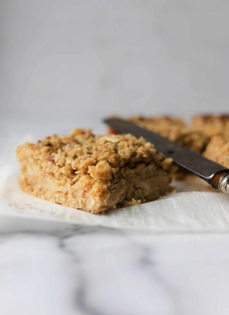 A slice of Ginger Pear Coffee Cake next to a silver butter knife.