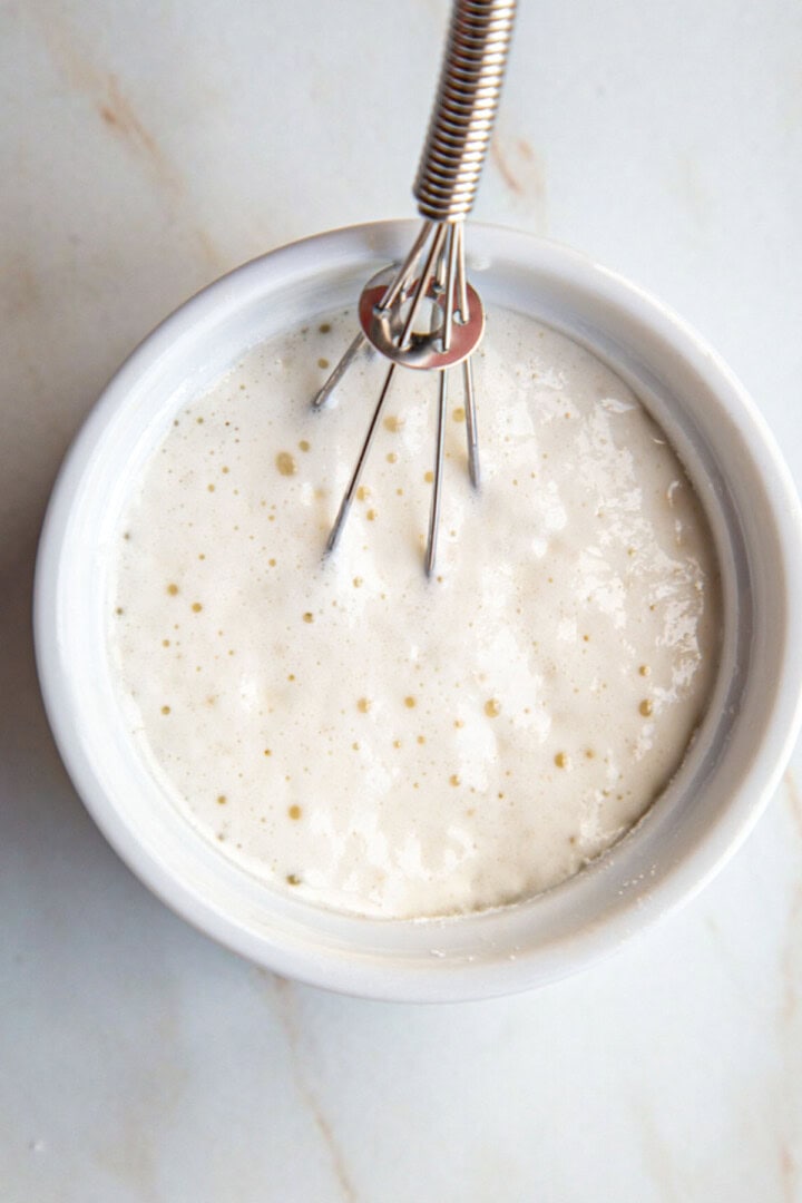 baking powder bubbling in a dish with a whisk.