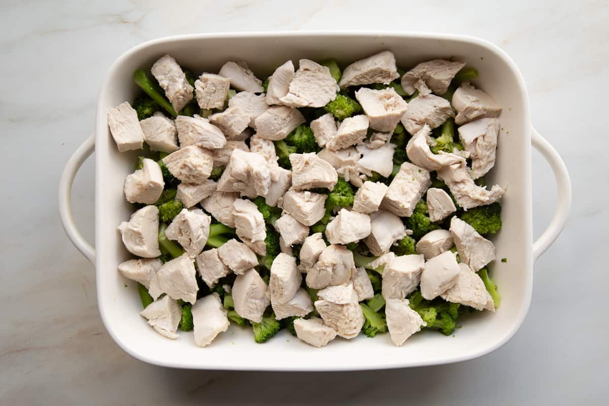 white baking pan filled with broccoli and chicken.