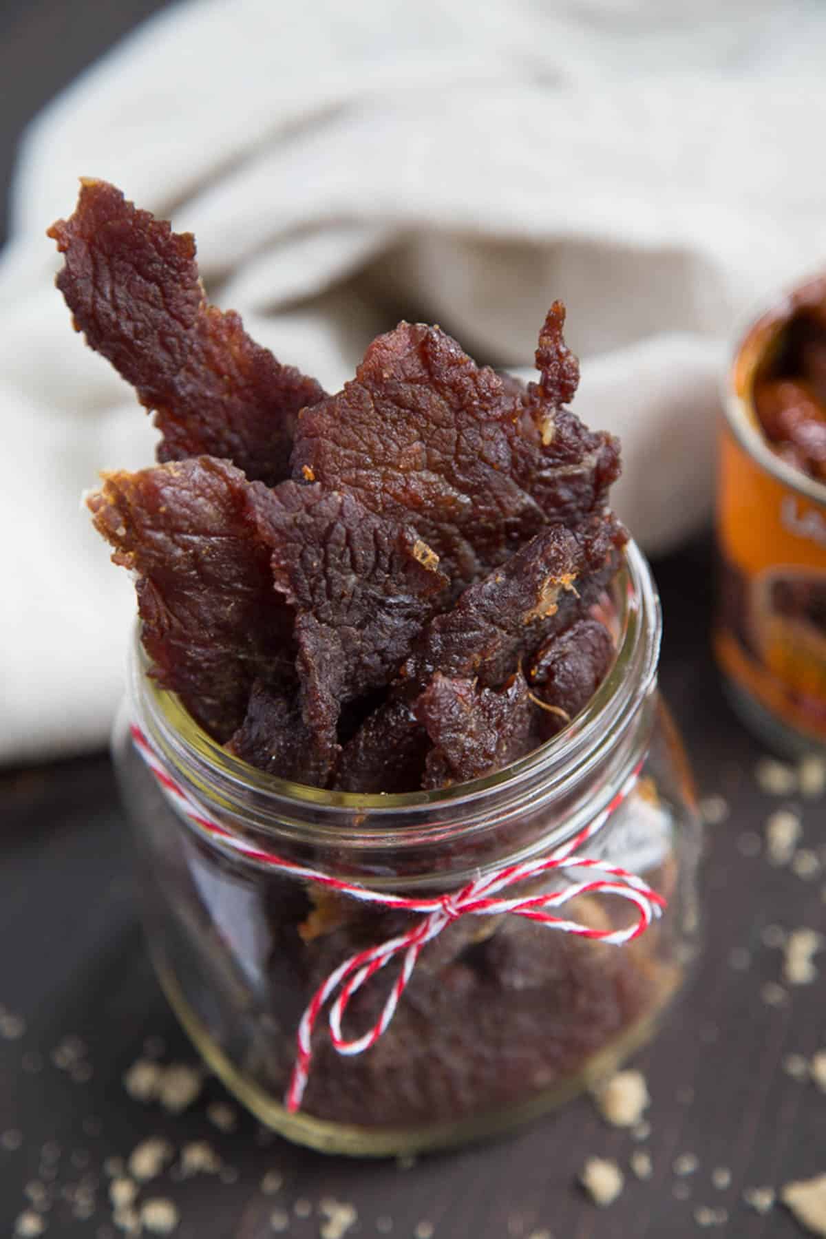 sweet and spicy jerky in a glass mason jar.