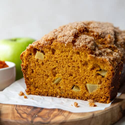 loaf of pumpkin apple bread topped with cinnamon streusel.