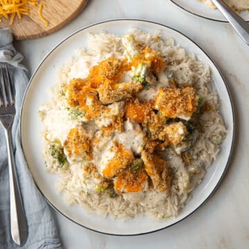 A large serving of Nixon Chicken Casserole over white rice on a white plate.