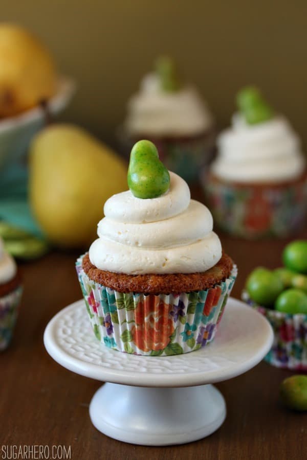 A Pear Cupcake on a small white cake plate.