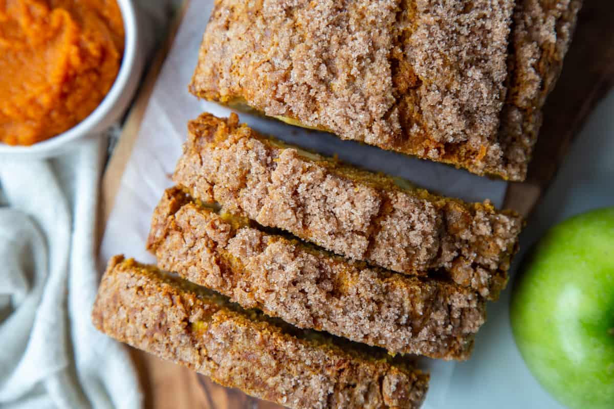 sliced pumpkin apple bread topped with cinnamon streusel.