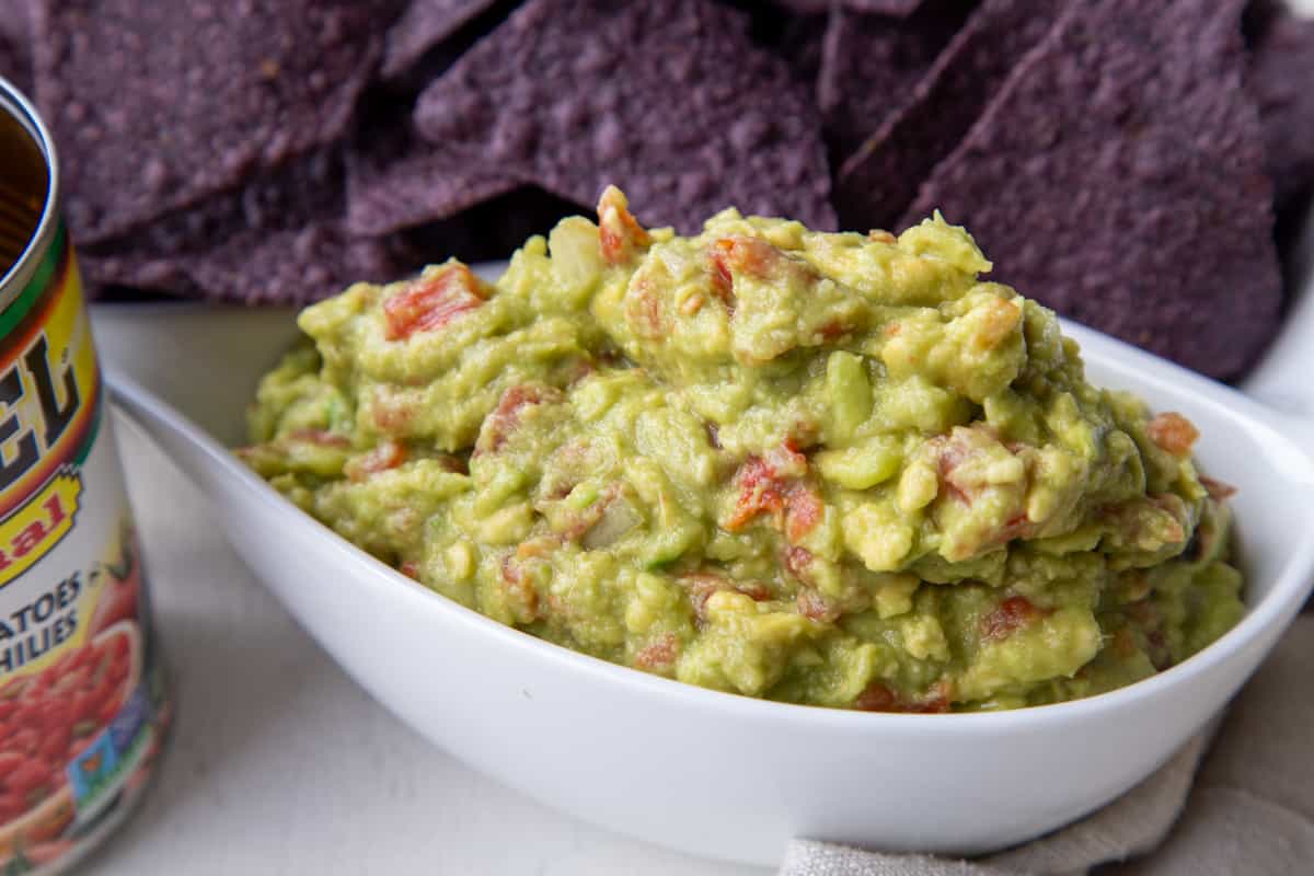 Close up of a white container or Rotel Guacamole.