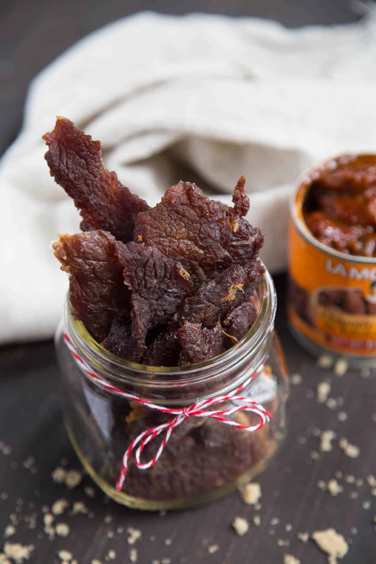 sweet and spicy beef jerky in a glass jar.