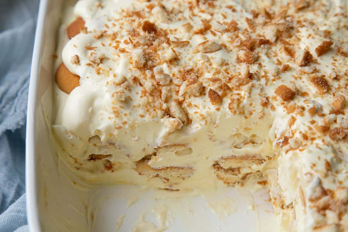 banana pudding inside a baking pan with portion removed to show layers