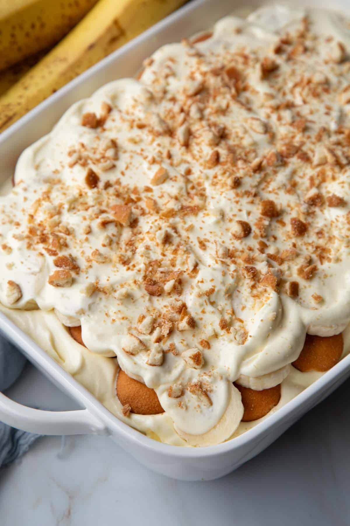 the top of no cook banana pudding in a white baking dish.