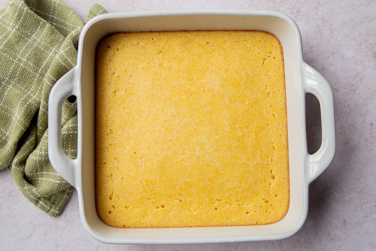 the top of baked cornbread in a white baking dish.