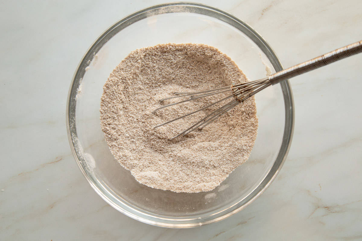 flour and sugar mixture in a glass bowl with a whisk.