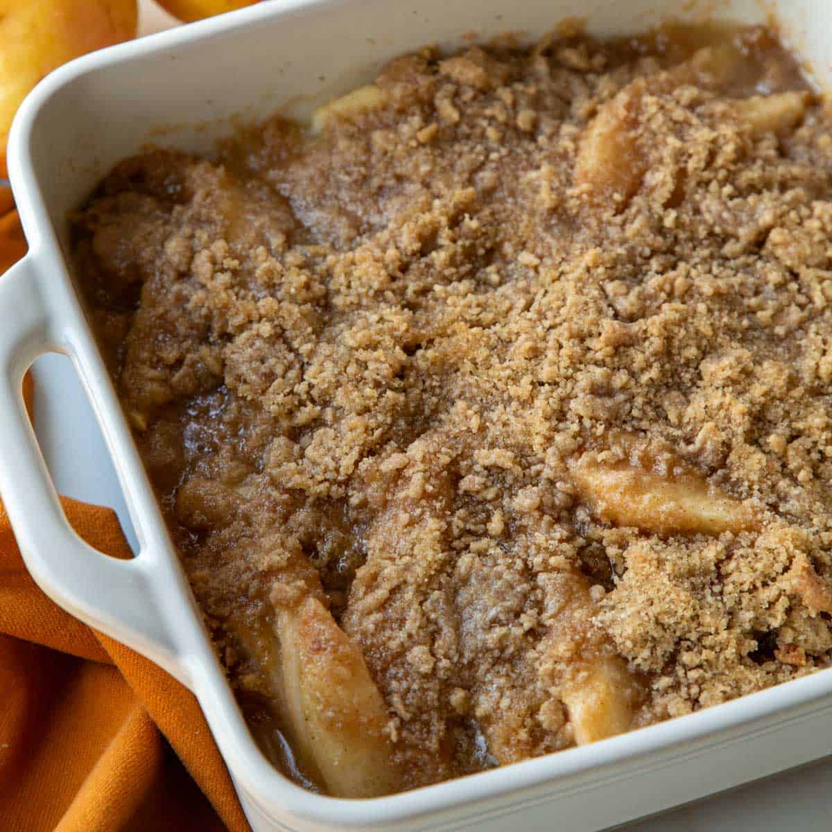 Top view of a baked Pear Crumble in a white baking dish.