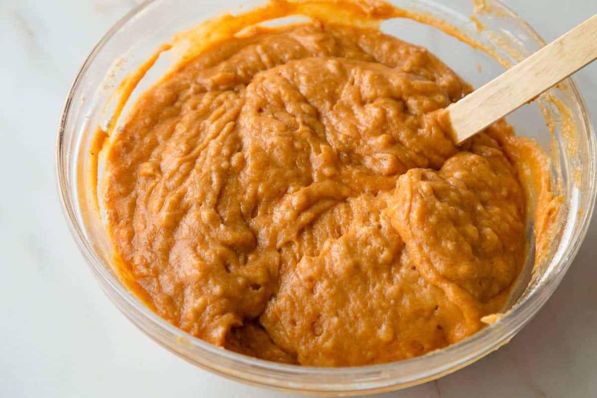 orange batter in a glass bowl.