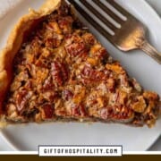 slice of pecan pie with a fork on a white plate.