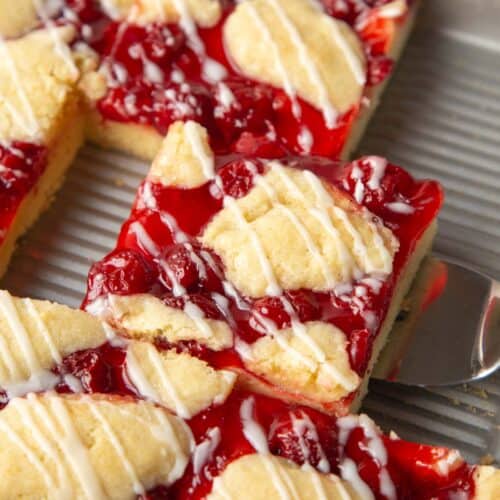 slice of cherry coffee cake in a pan.