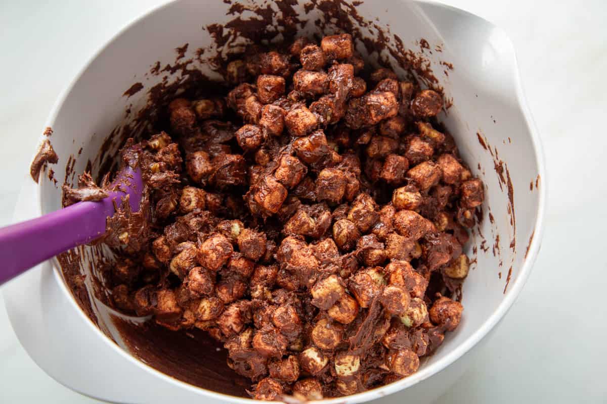 chocolate marshmallow mixture in a white mixing bowl.