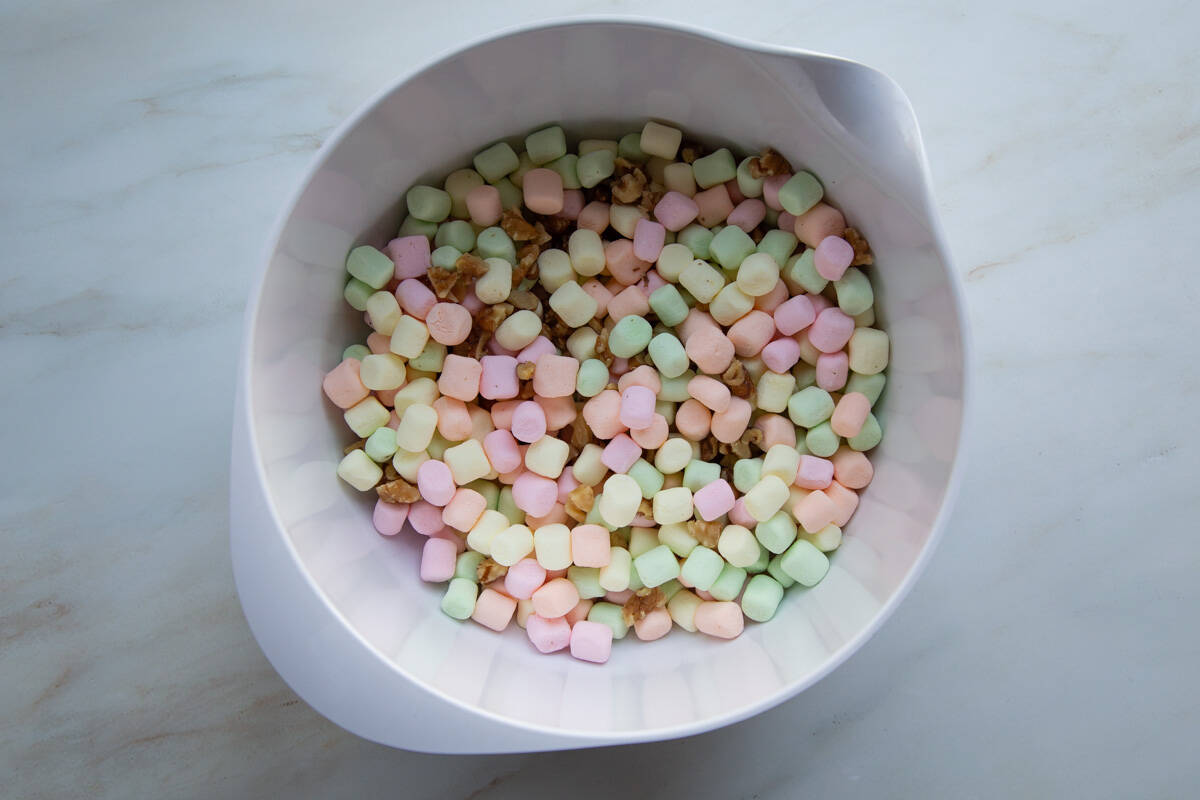 fruity mini marshmallows and walnuts in a large mixing bowl.