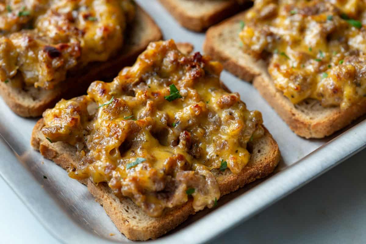 close up of a broiled hanky panky appetizer on a baking sheet.