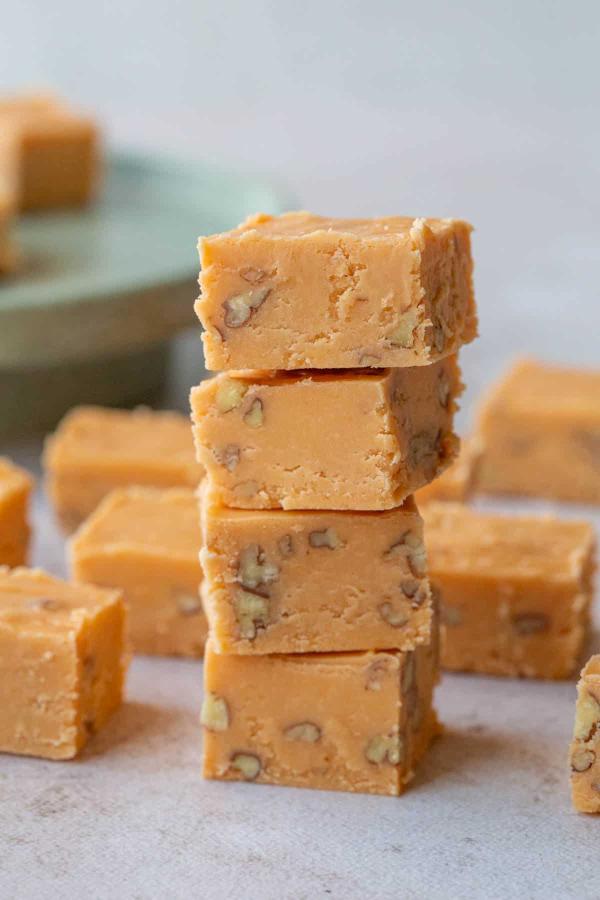 four pieces of butterscotch fudge stacked up.