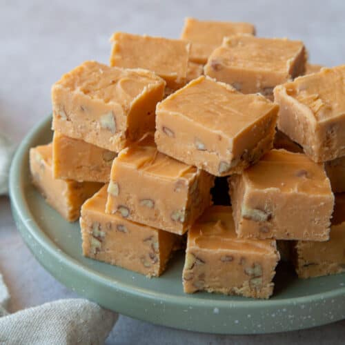 pieces of butterscotch fudge on a green platter.