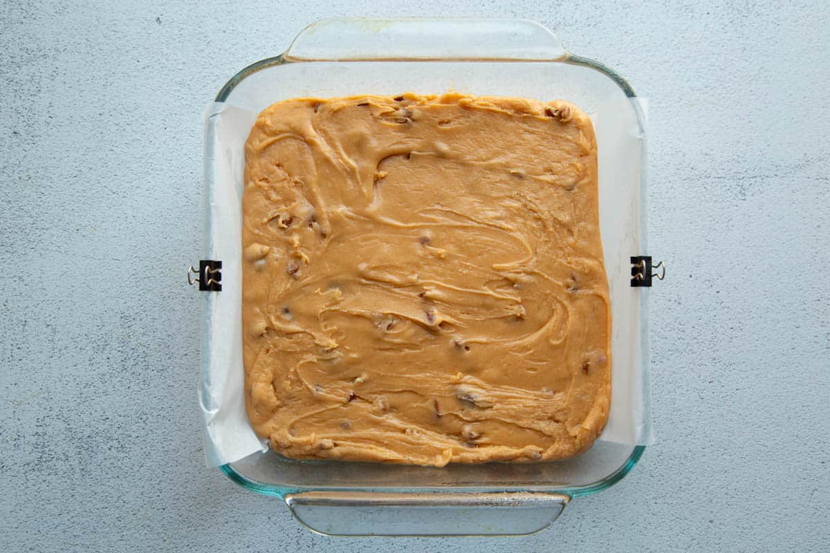 butterscotch fudge in a glass pan before setting up.