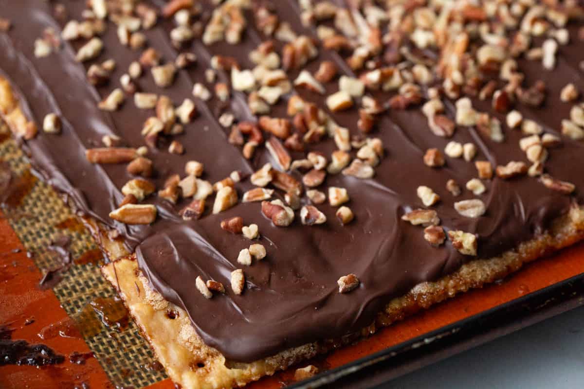 saltine cracker candy on a silicone baking mat.