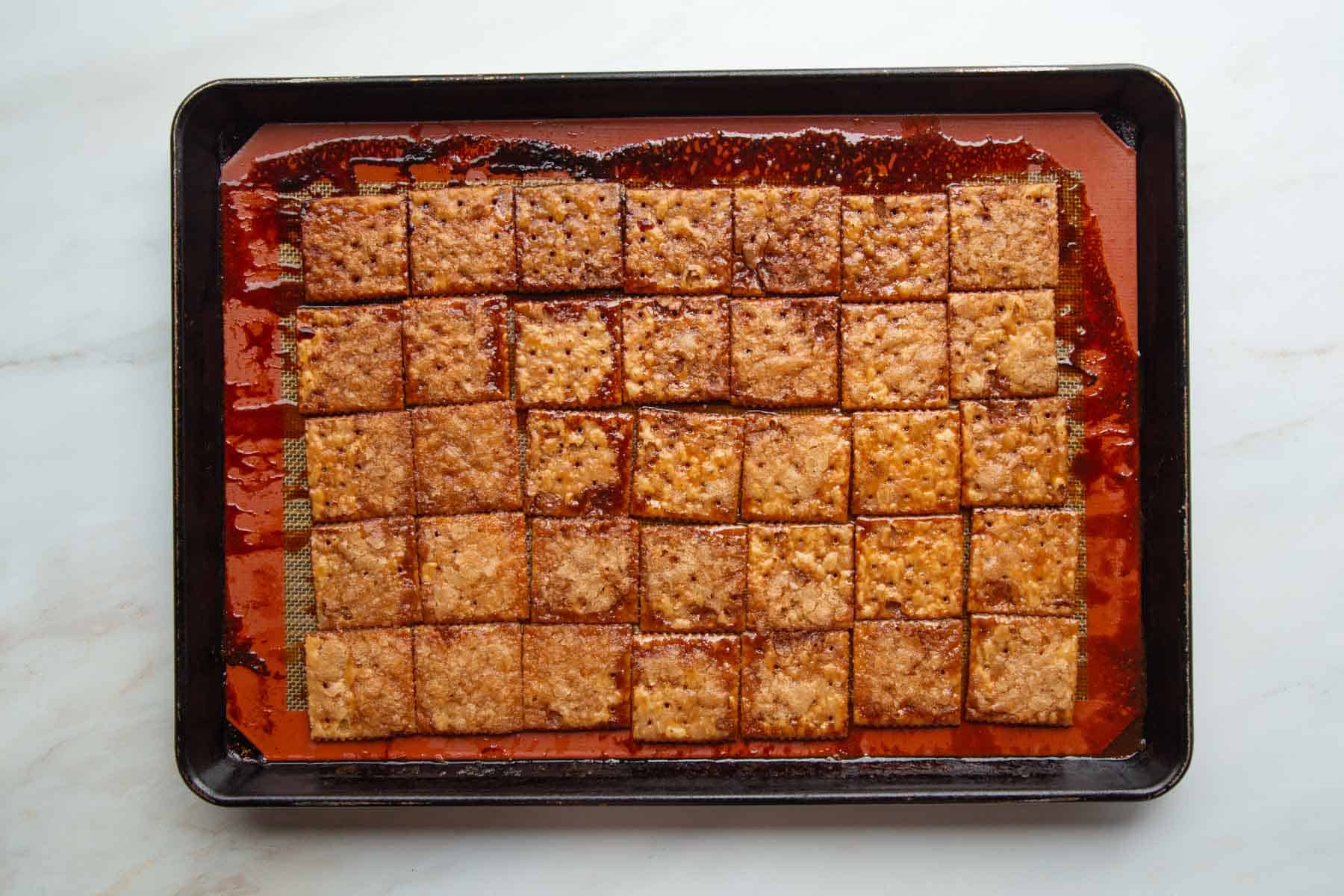 baked and caramelized saltine crackers on a baking sheet.