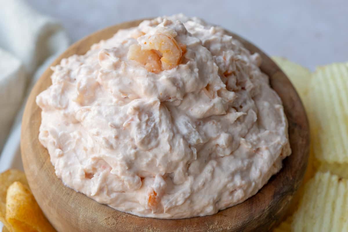 A wooden bowl filled with shrimp dip.