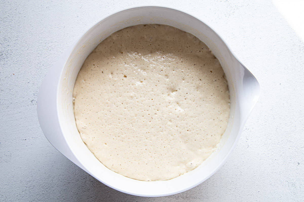 batter with bubbles in it, in a white bowl.