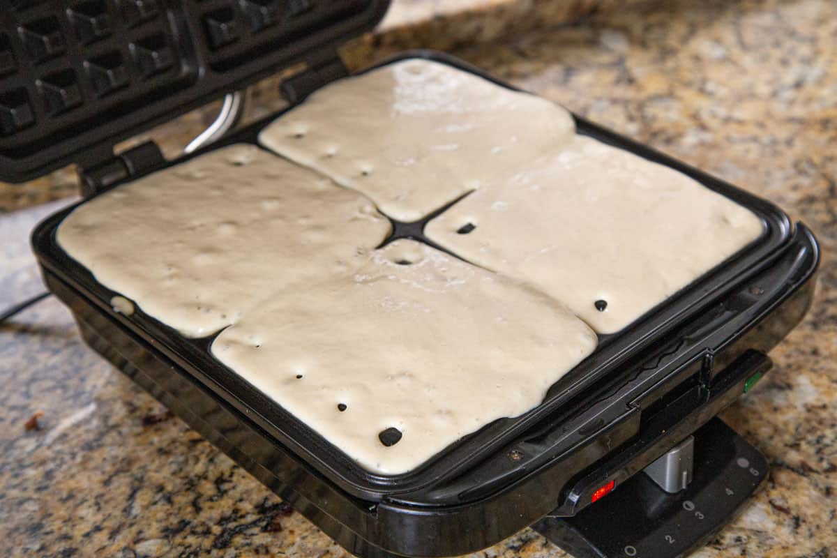 waffle batter in a square waffle iron.