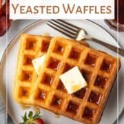 waffles on a plate with butter and syrup.