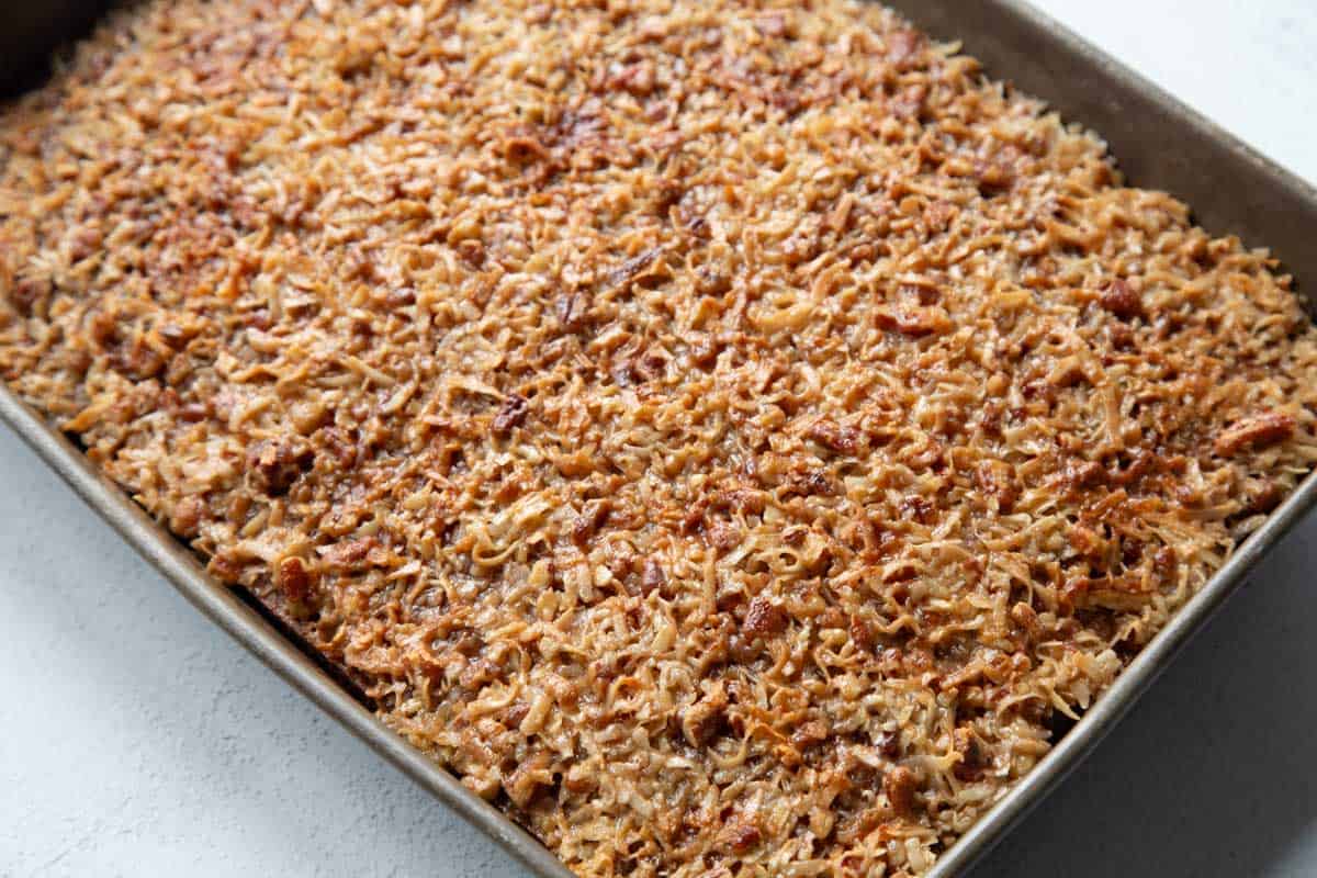 coconut pecan topped oatmeal cake in a metal pan.