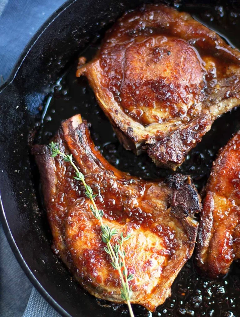honey glazed pork chops in a skillet.