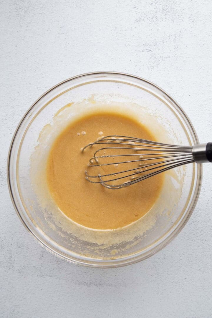 egg mixture with sugar in a glass bowl.