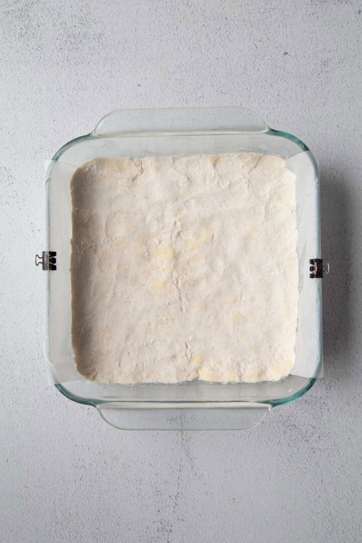 glass dish filled with a shortbread mixture that's unbaked.