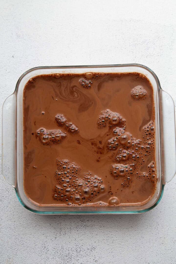 water over cake batter in a glass pan.