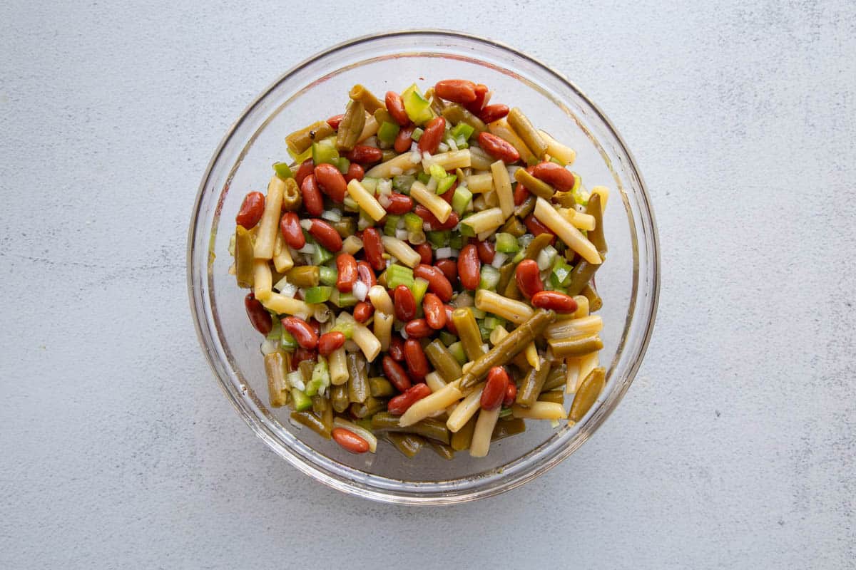 dry ingredients and canned beans mixed together in a glass mixing bowl.