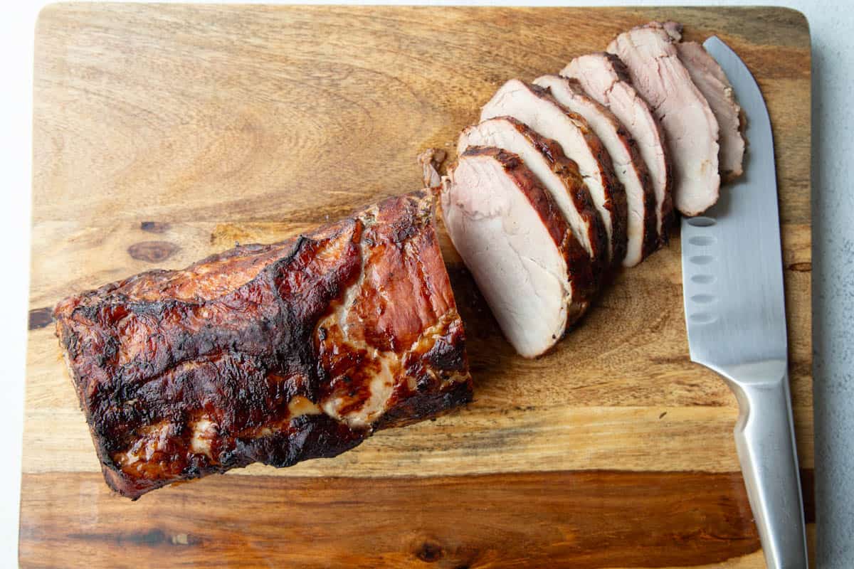 sliced pork roast on a cutting board.
