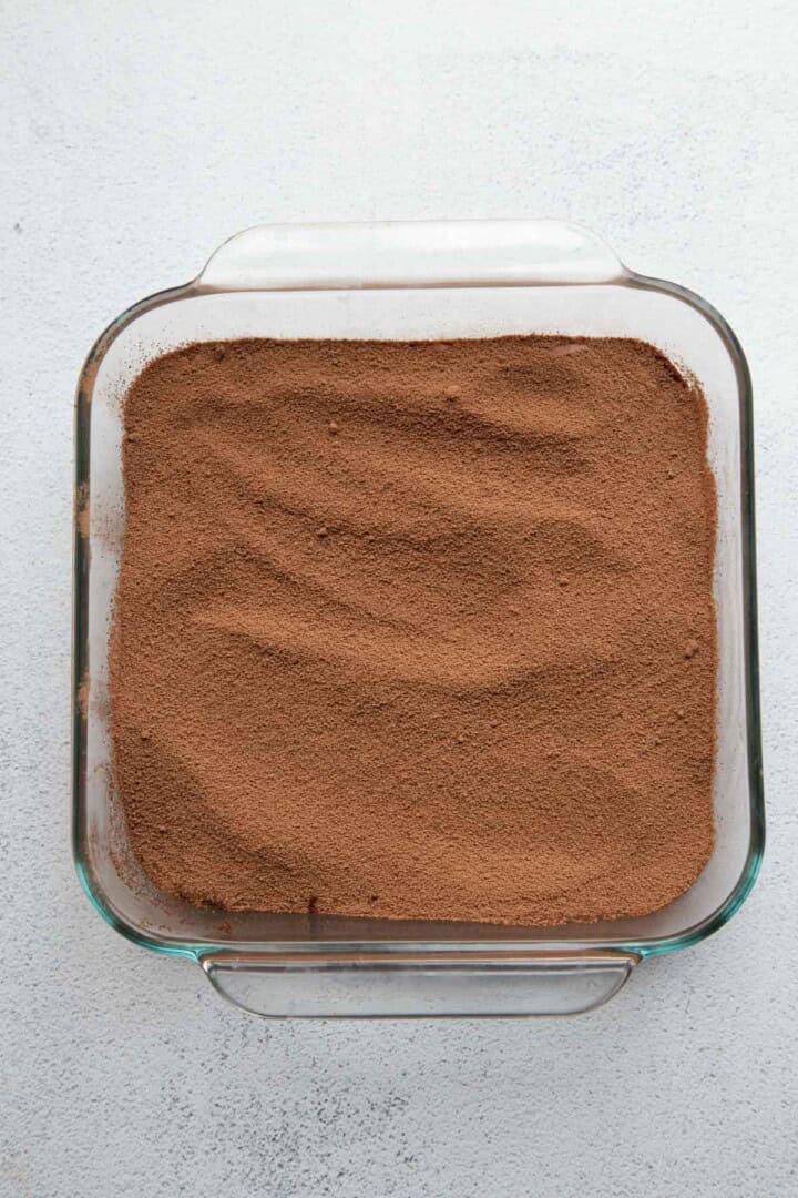 cocoa powder mixture in a glass pan.