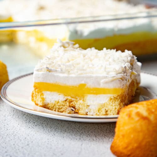 slice of twinkie cake on a white plate, next to a whole twinkie.