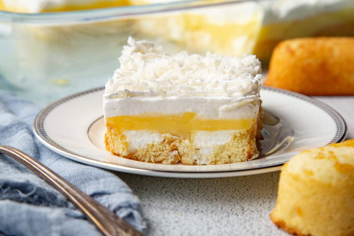 slice of layered twinkie cake on a white plate.