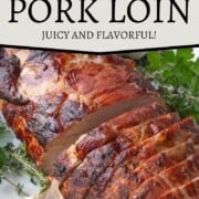 sliced pork loin roast with a golden exterior on a white platter.