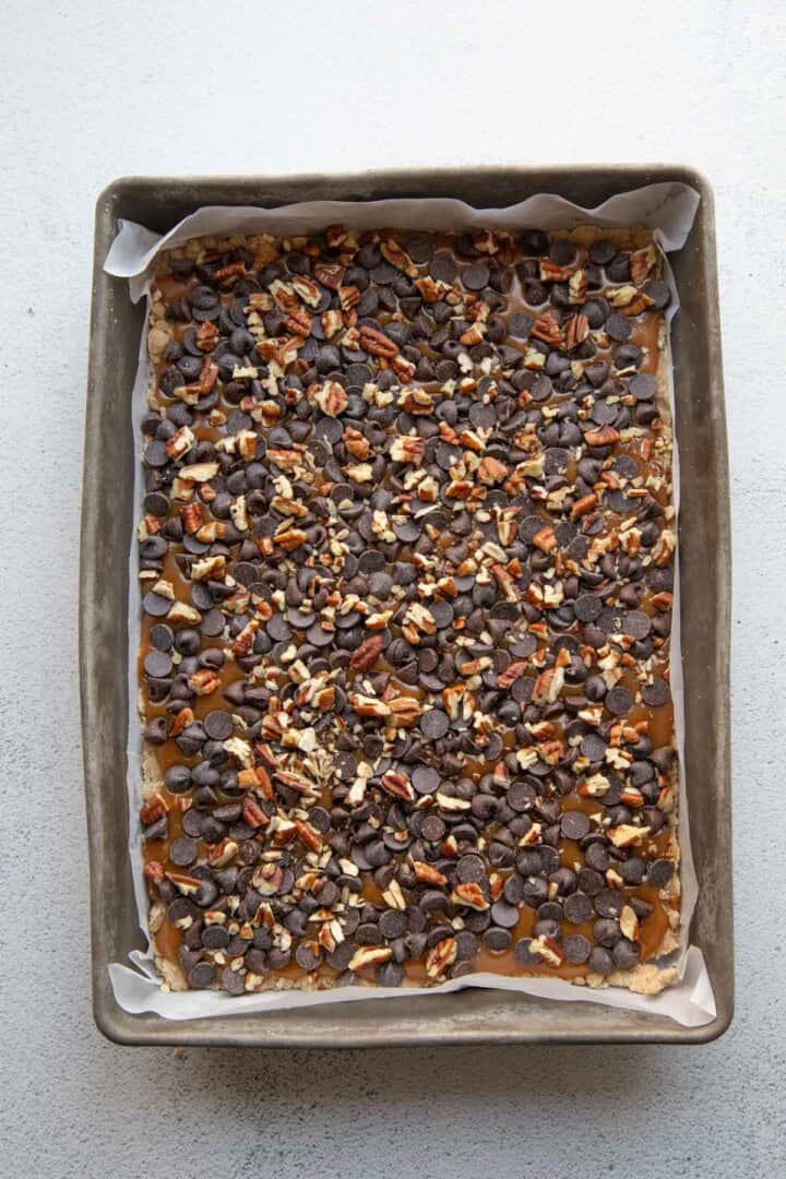 chocolate chips and caramel in a metal pan.