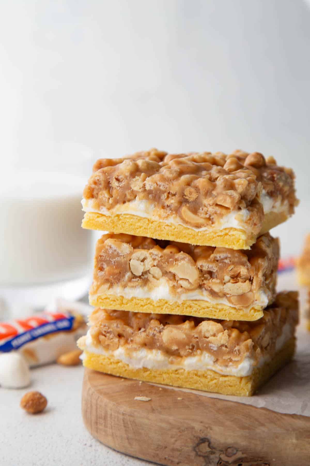 pay day cookie bars stacked on a wooden board.