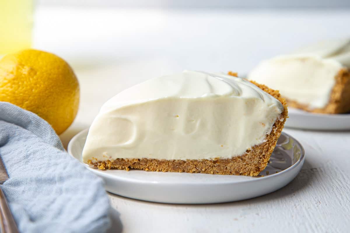 slice of lemonade pie on a graham cracker crust.