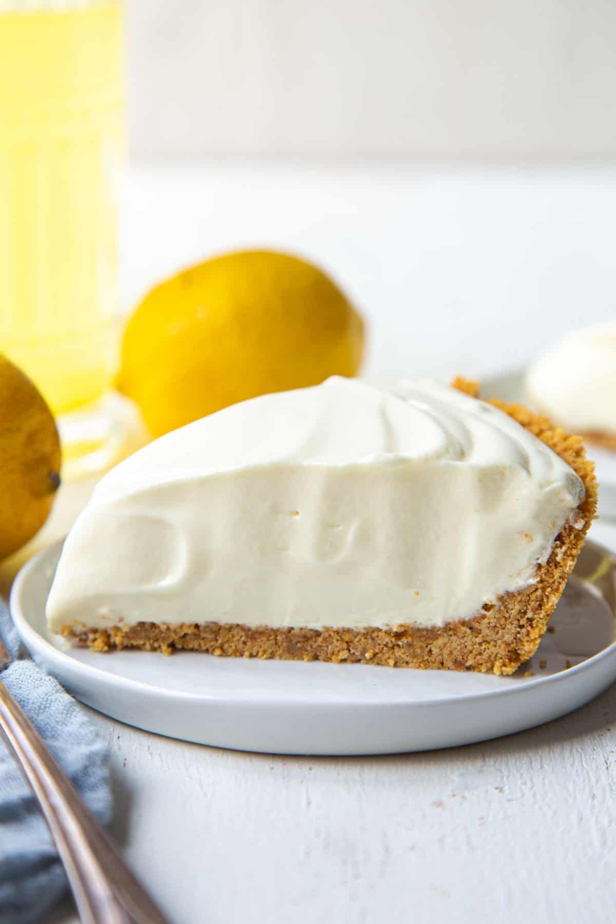 slice of lemonade pie on a white plate.