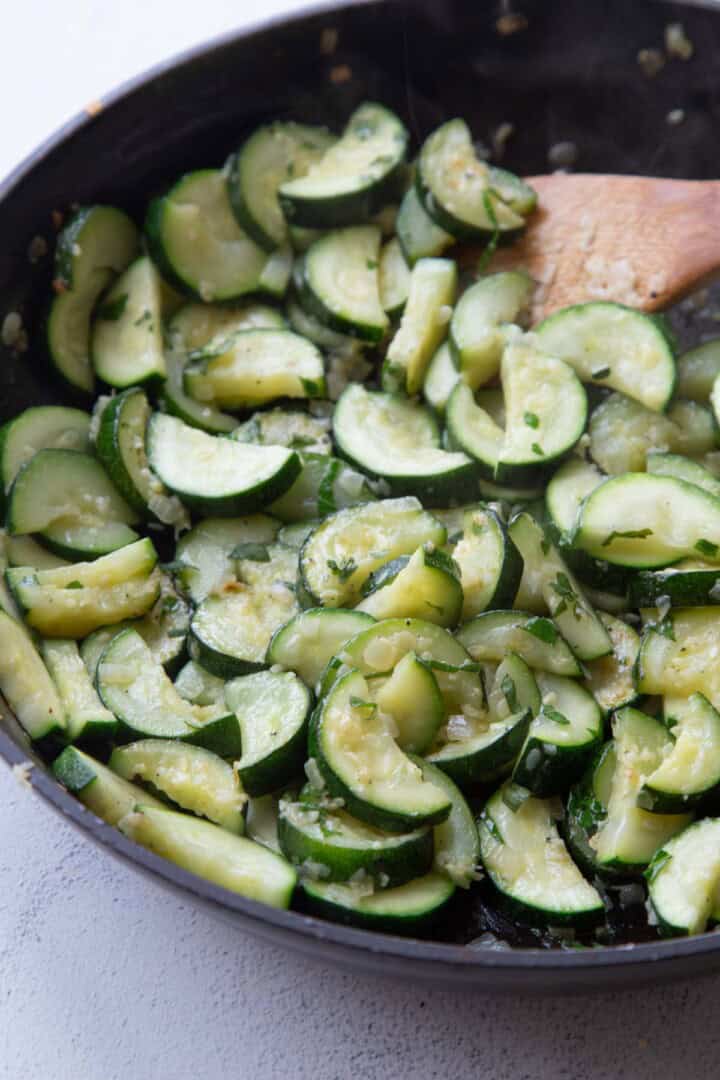 sauteed zucchini in a skillet.