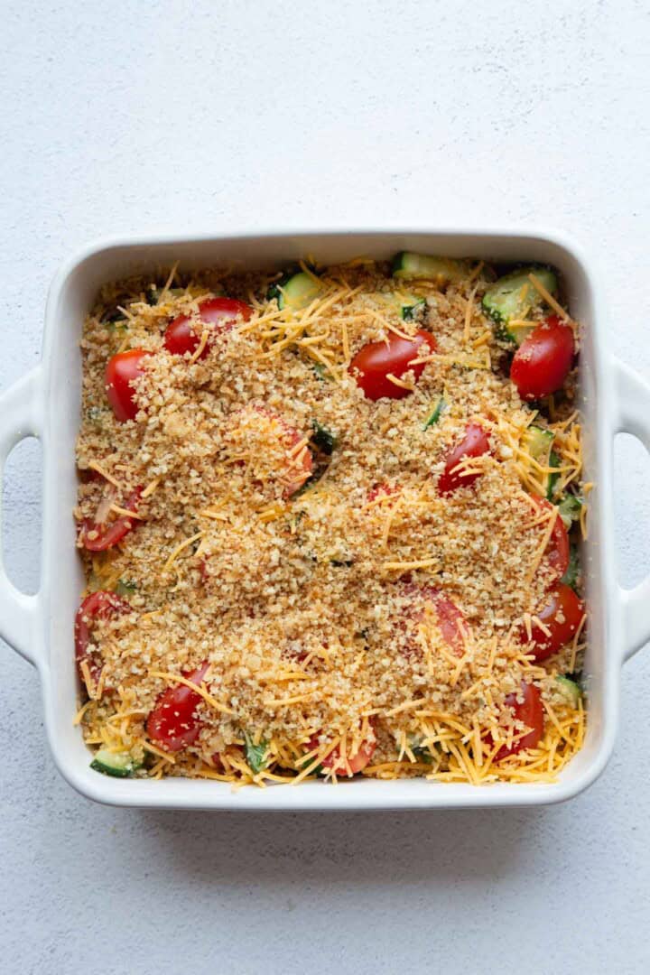 zucchini, tomatoes, and cheese topped with breadcrumbs.