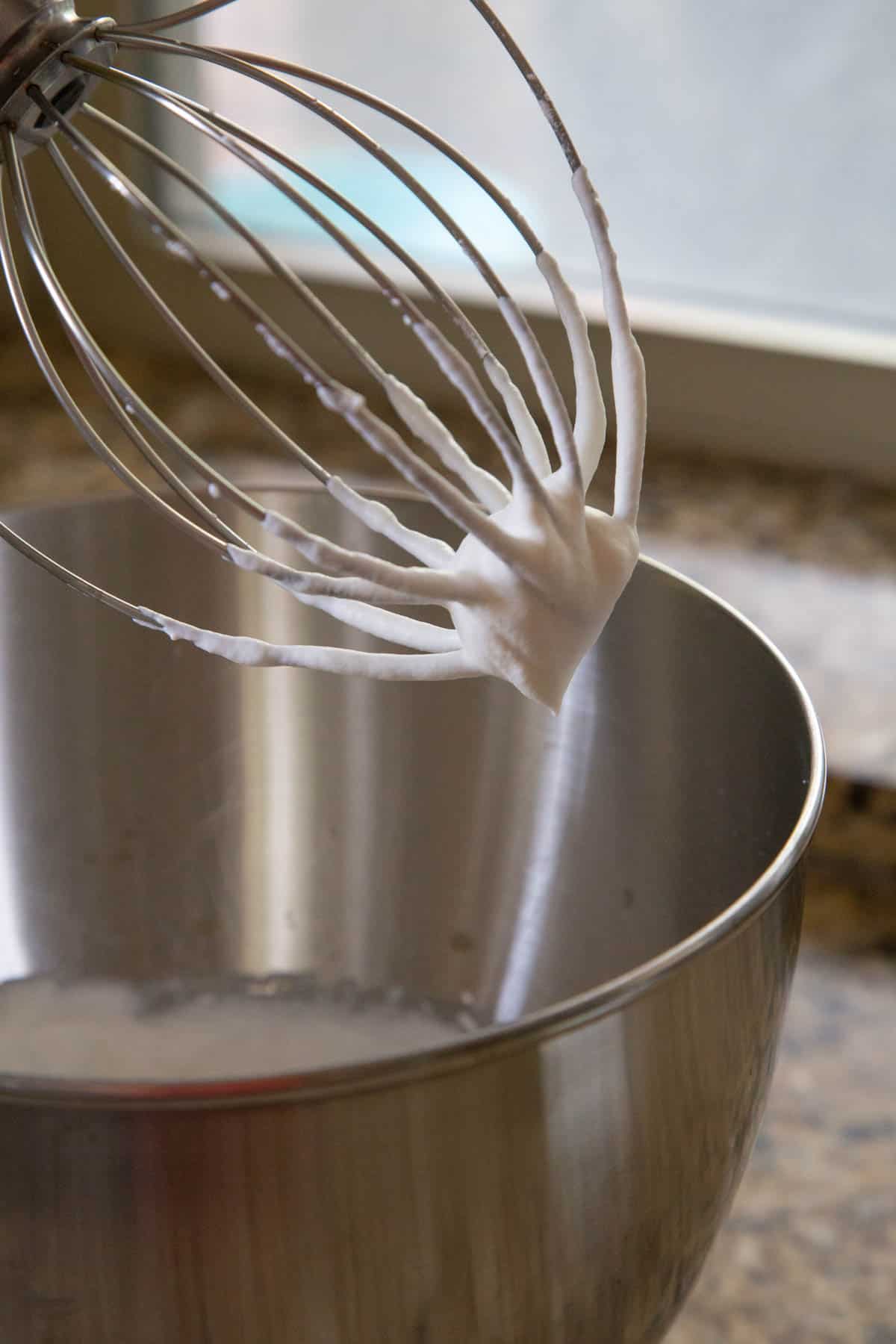 whipped cream in a stand mixer with a whisk attachment.