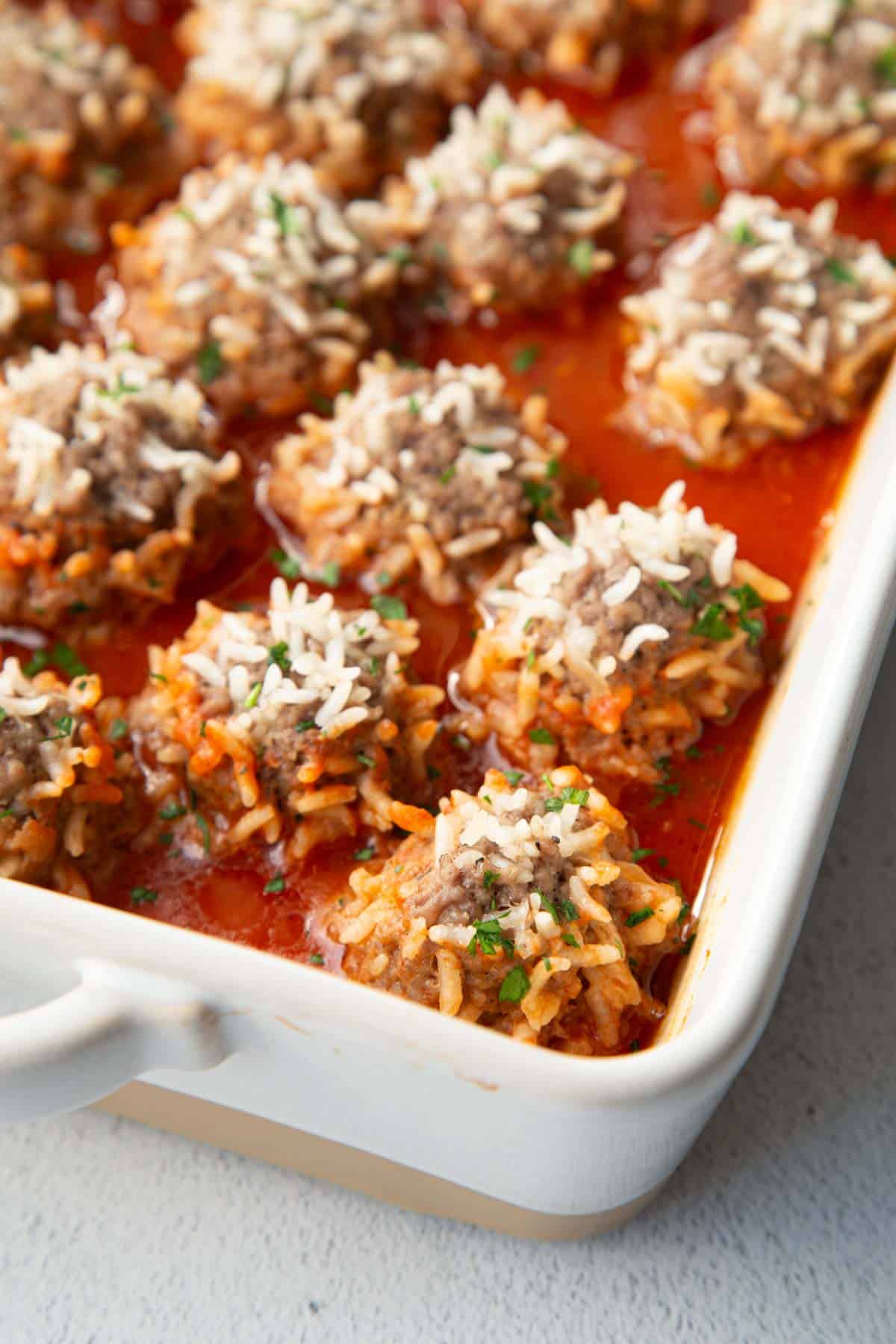 casserole dish filled with porcupine meatballs in tomato soup.