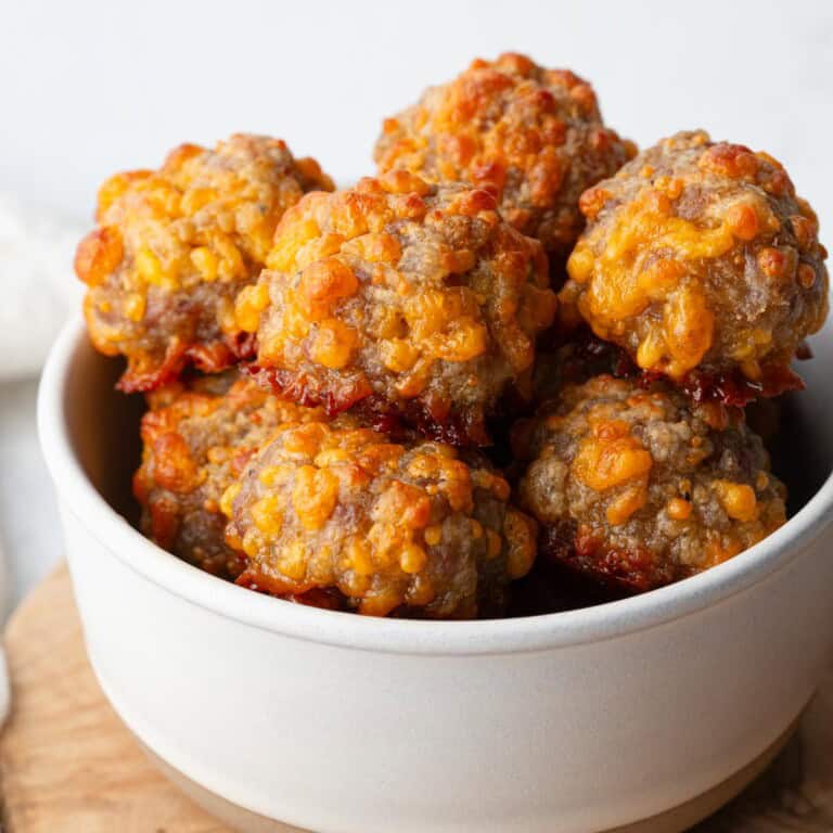 cheesy sausage balls in a white bowl.